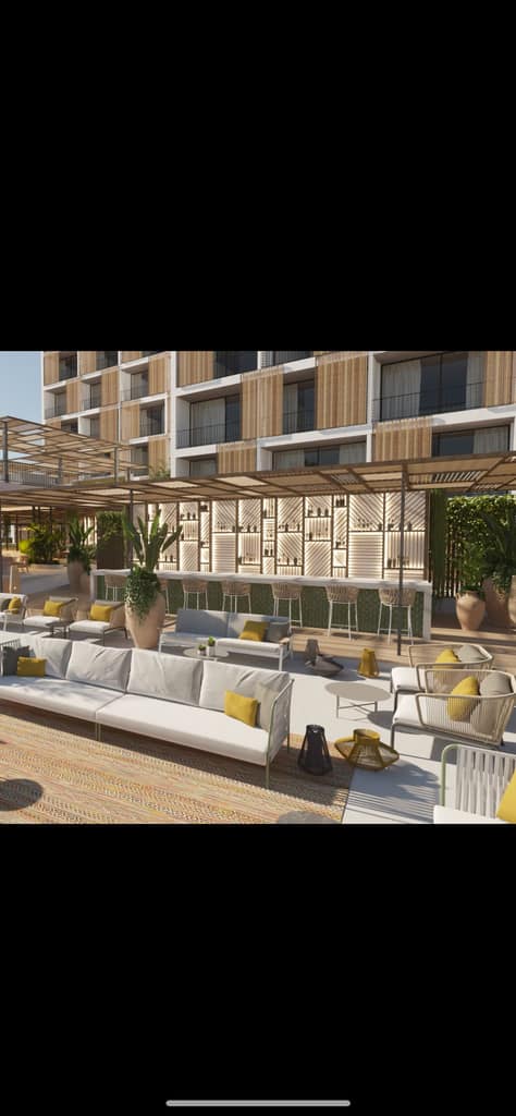 Terraza de hotel con celosías y paneles de madera en fachada y barra, Ibiza