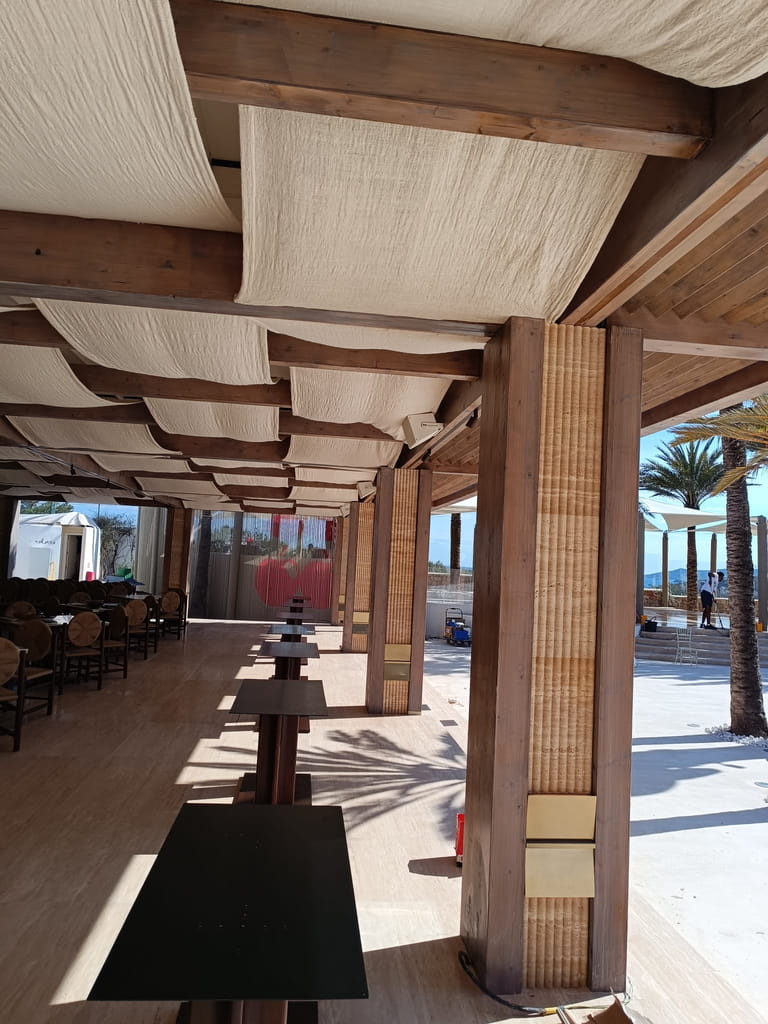 Porche de madera con toldos de tela en la terraza de un restaurante en Ibiza